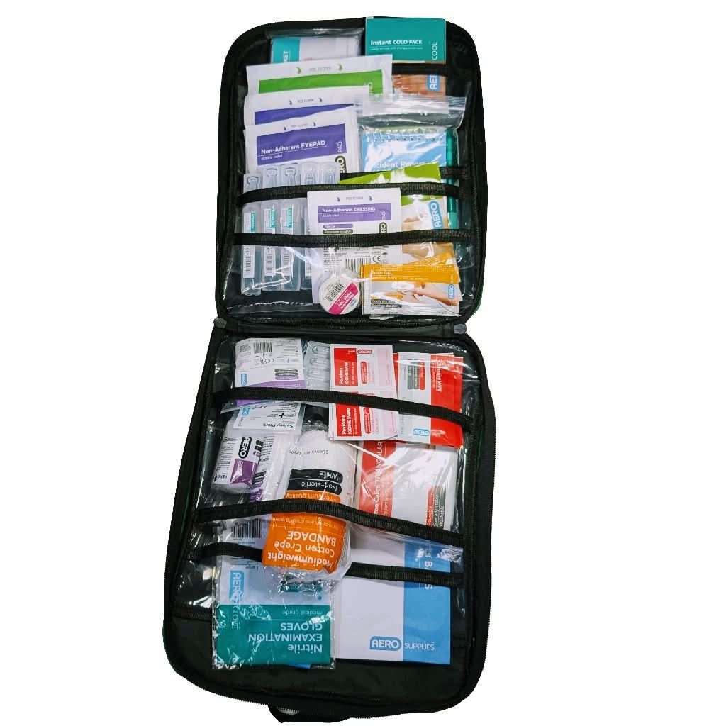 Green A4 sized WHS compliant first aid kit. Built in Dubbo NSW by Assurance First Aid Kits. Internal view of top and bottom panel contents.