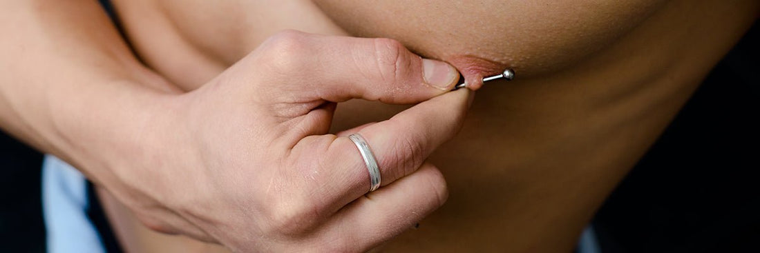 BLOG  man showing his nipple piercing