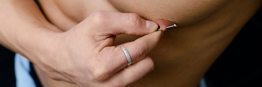BLOG  man showing his nipple piercing