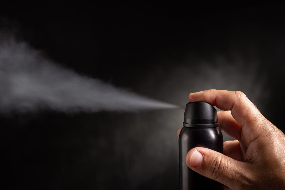 BLOG black aerosol can being sprayed into the air