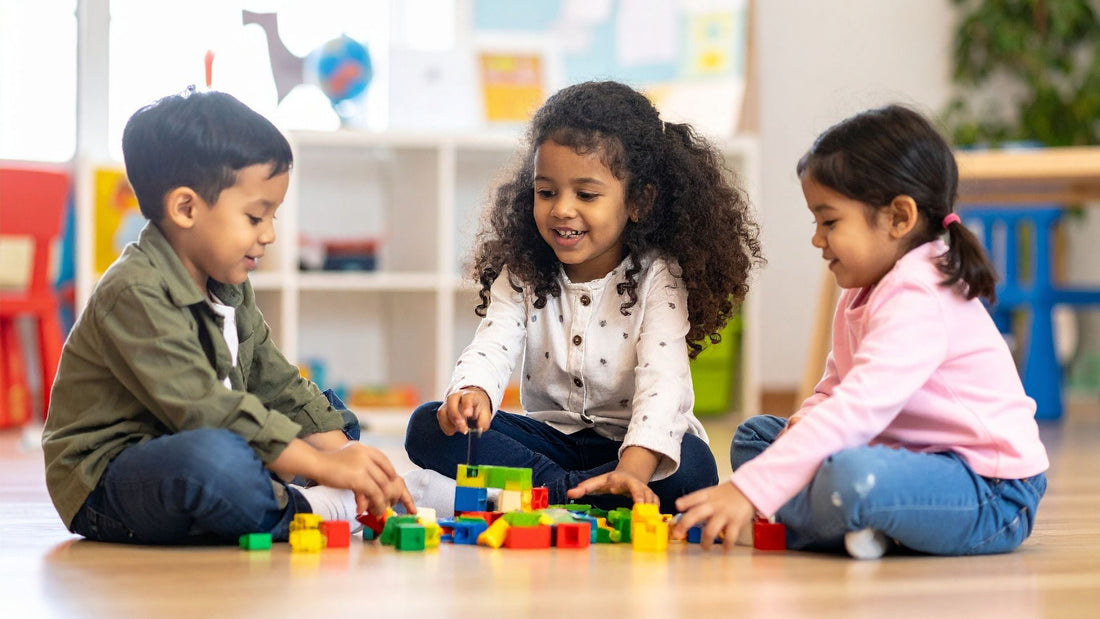 BLOG 3 children playing happily with some blocks on the floor at a day care centre