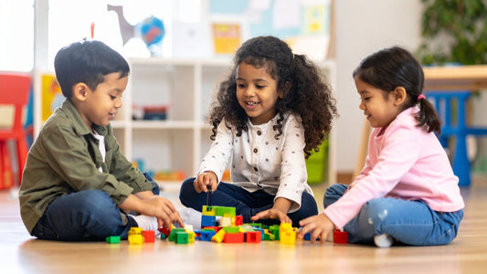 BLOG 3 children playing happily with some blocks on the floor at a day care centre